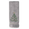 White terry cotton hand towel featuring a green rhinestone Christmas tree design with red ornaments and a gold star on top.