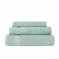 Three stacked towels in black and white featuring rhinestone embellishments on the stripes made of cotton with a plush texture.