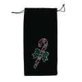 Red velvet wine bag featuring a rhinestone candy cane design with a green bow and drawstring closure. Red velvet wine bag featuring a rhinestone candy cane design with a green bow and drawstring closure.