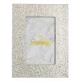 A rectangular silver picture frame embellished with glass rhinestones featuring a marble-patterned background and gold text. A rectangular silver picture frame embellished with glass rhinestones featuring a marble-patterned background and gold text.