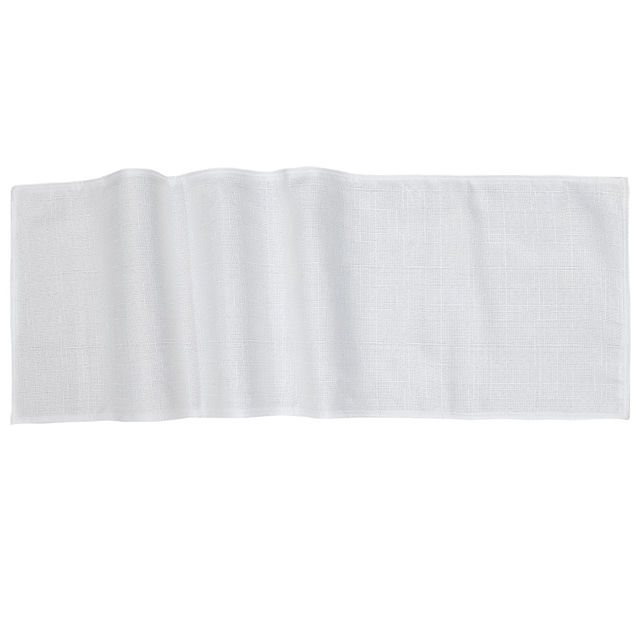 Woven table runner in textured gray fabric with a subtle heather pattern and wavy edges.