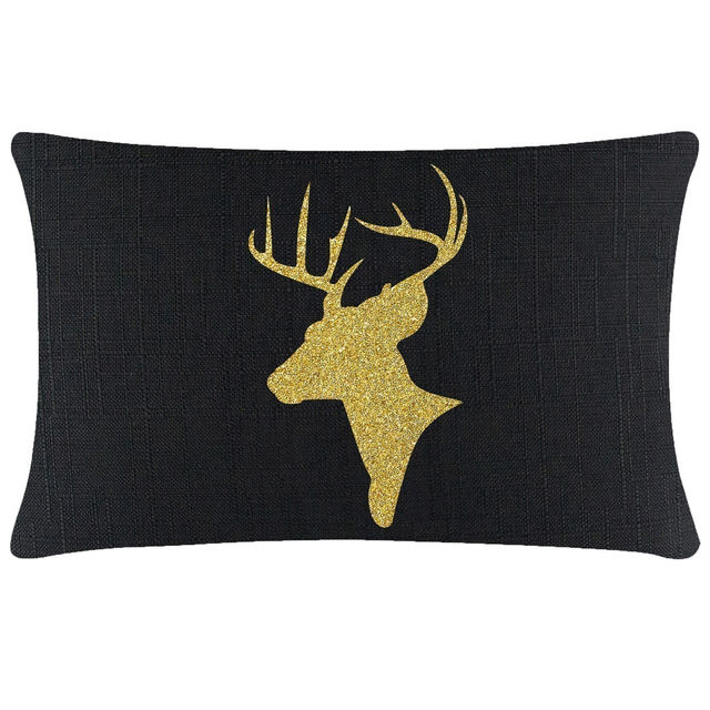 Green velvet pillow featuring a gold glitter reindeer silhouette with antlers on a smooth surface.