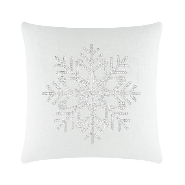 White square pillow featuring a rhinestone snowflake design in the center on a textured fabric surface.