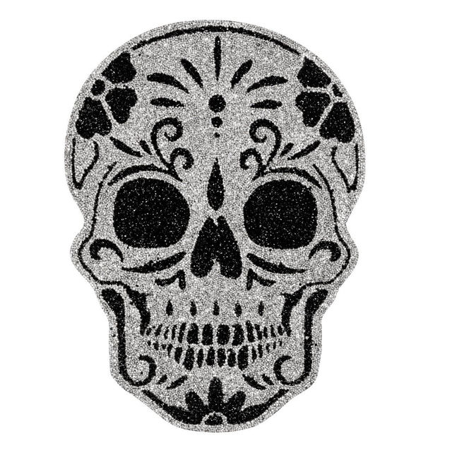 A&#x20;silver&#x20;glitter&#x20;skull&#x20;placemat&#x20;with&#x20;black&#x20;floral&#x20;designs&#x20;and&#x20;large&#x20;eye&#x20;sockets&#x20;featuring&#x20;intricate&#x20;detailing&#x20;and&#x20;a&#x20;smooth&#x20;texture.