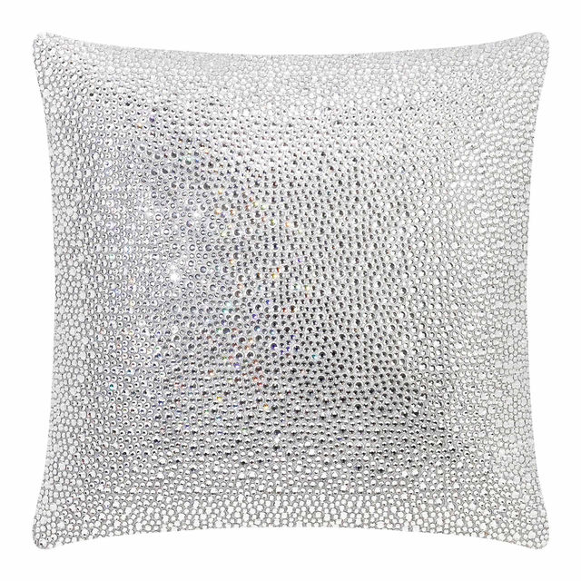 Square pillow covered in shimmering silver rhinestones on a soft velvet texture.