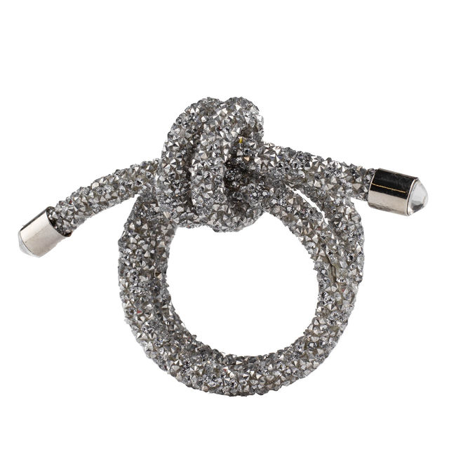 Silver wire napkin ring shaped as a knot embellished with rhinestones and featuring smooth metallic ends.
