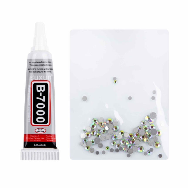 A tube of clear adhesive beside a clear pouch filled with silver and iridescent rhinestones of various sizes and shapes.