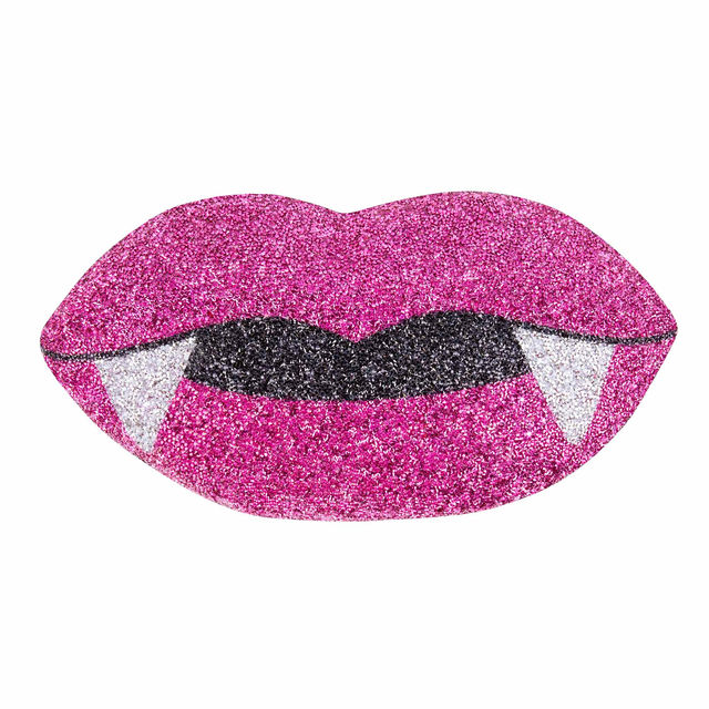 Pink glittery lips shaped pillow with black fangs featuring a shiny texture and a sparkling finish.