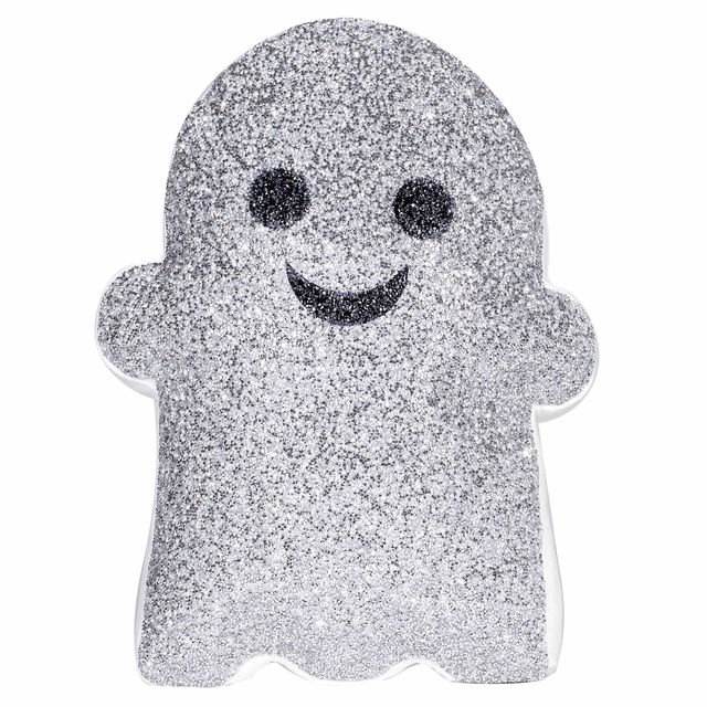 Silver glitter ghost-shaped pillow with black eyes and a smiling mouth featuring a plush texture and a white border.