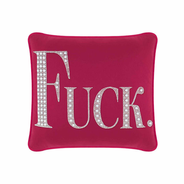 White velvet pillow with large rhinestone and faux pearl lettering spelling "FUCK" in silver embellishments.