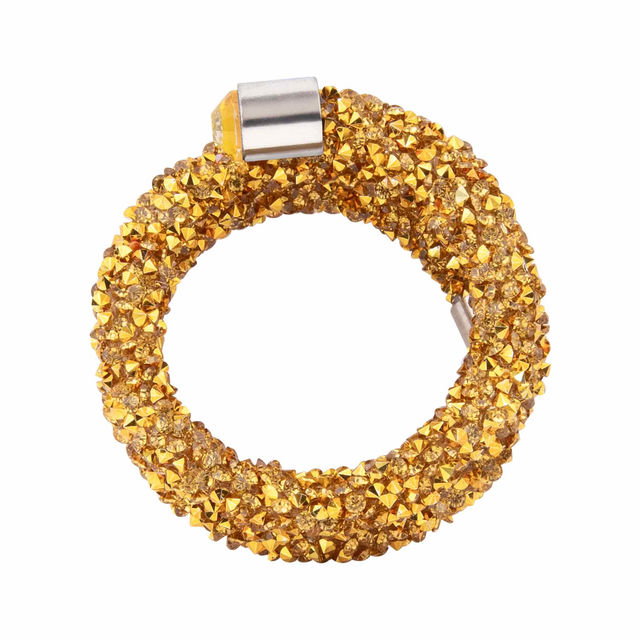 Gold napkin ring made of flexible wire adorned with sparkling golden crystals and silver metal accents. Gold napkin ring made of flexible wire adorned with sparkling golden crystals and silver metal accents.