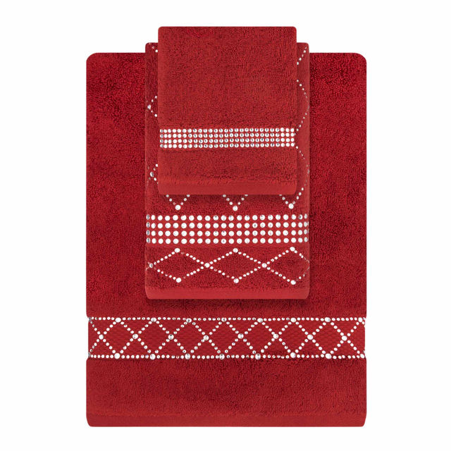 Three black towels stacked with shimmering geometric bands in fingertip, hand, and bath sizes Three black towels stacked with shimmering geometric bands in fingertip, hand, and bath sizes