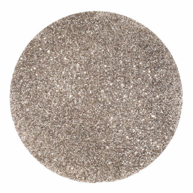 Round silver placemat with a textured surface adorned with vibrant rhinestones reflecting light for a sparkling effect.