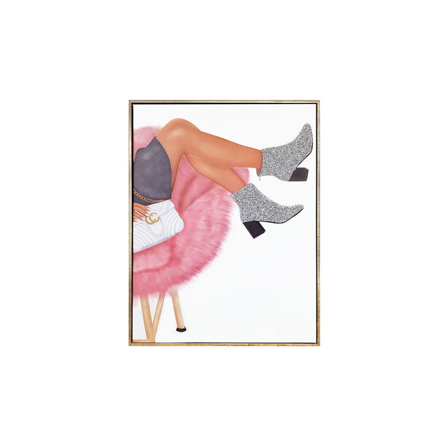 A pair of silver rhinestone ankle boots on a canvas with a metallic gold frame and a pink fluffy chair in the background. A pair of silver rhinestone ankle boots on a canvas with a metallic gold frame and a pink fluffy chair in the background.