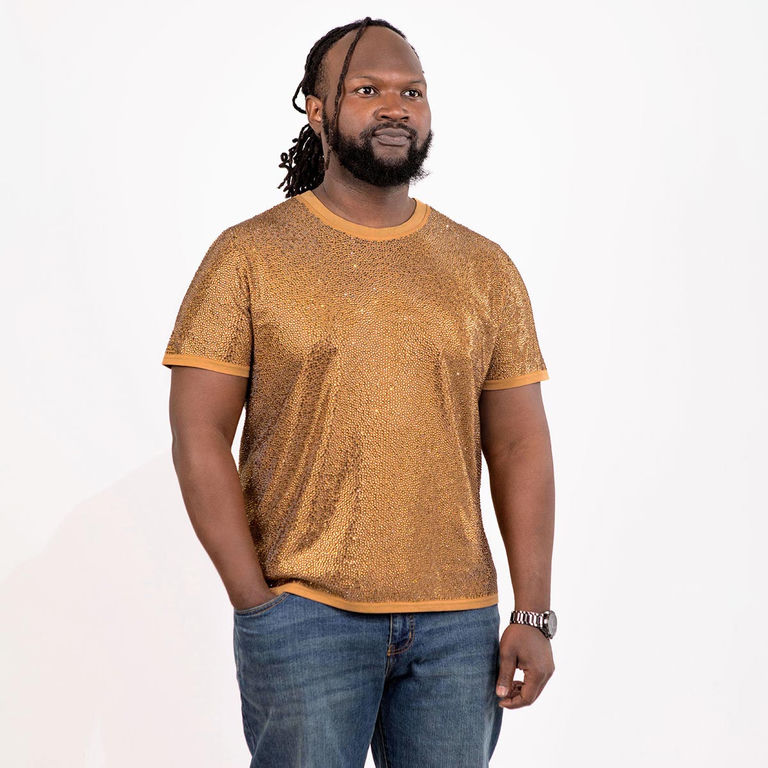 Man wearing a gold rhinestone T-shirt with short sleeves