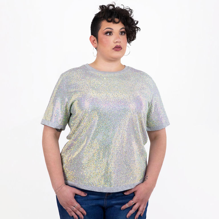 Model wearing an iridescent rhinestone T-shirt with short sleeves and a straight fit