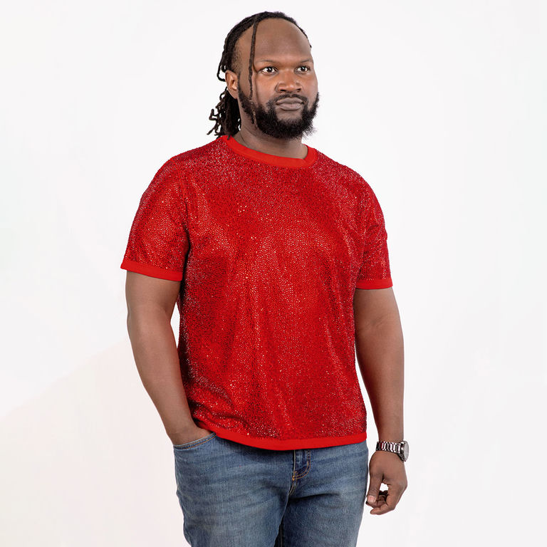 Man wearing a red rhinestone T-shirt with short sleeves and a crew neck