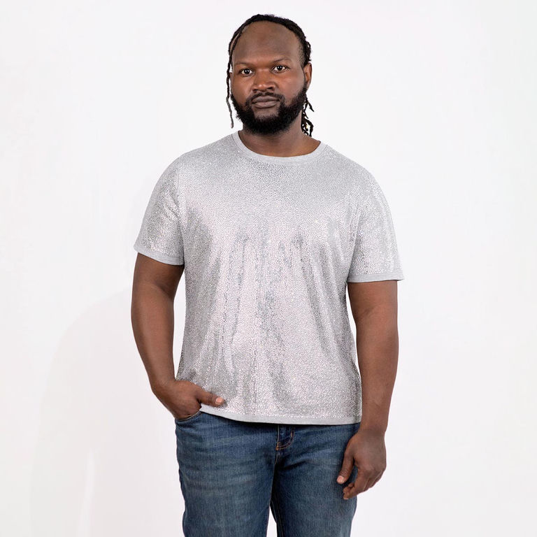 Man wearing a silver rhinestone T-shirt with short sleeves and a straight fit