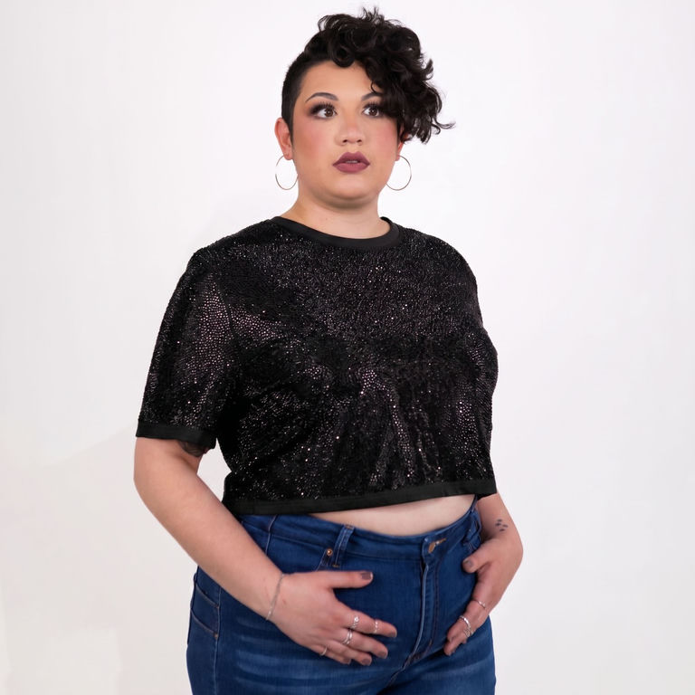 Model wearing a black strass rhinestone crop top with short sleeves