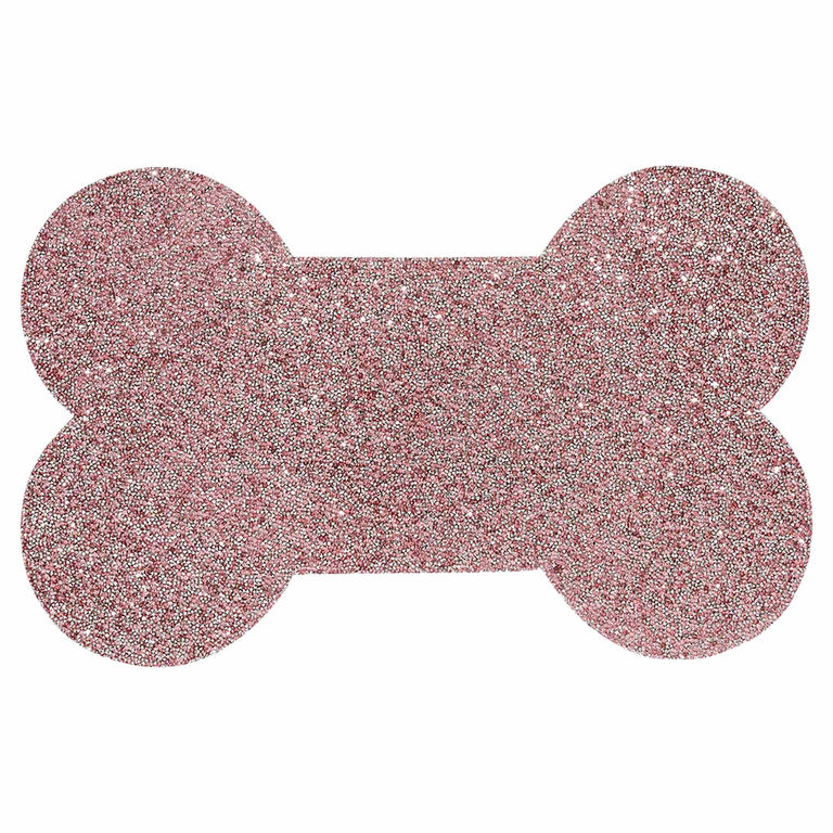 Pink dog bone-shaped placemat with a non-slip rhinestone-studded surface and a textured sparkling finish.