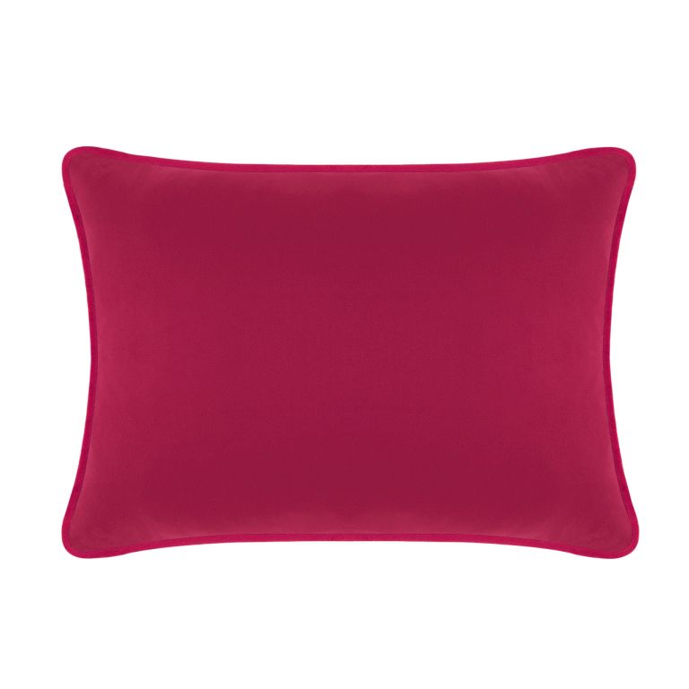 Fuchsia velvet rectangular pillow with a smooth texture and piped edges measuring 14x20 inches.