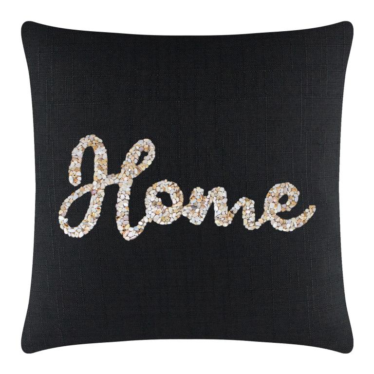 Black square pillow with textured fabric featuring a seashell "Home" design in cream and beige tones.