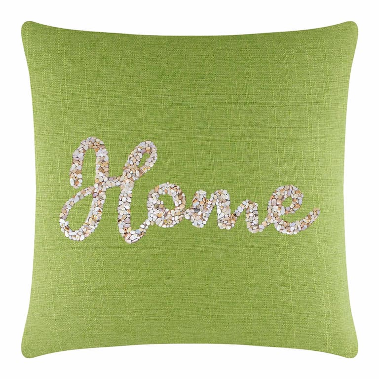 Lime green pillow with a textured fabric featuring a seashell design spelling "Home" in neutral tones.
