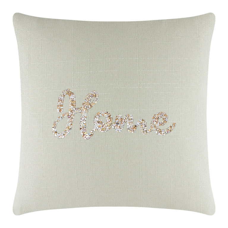 Square pillow in light aqua linen with textured weave and seashell "home" design in beige and white embellishments.
