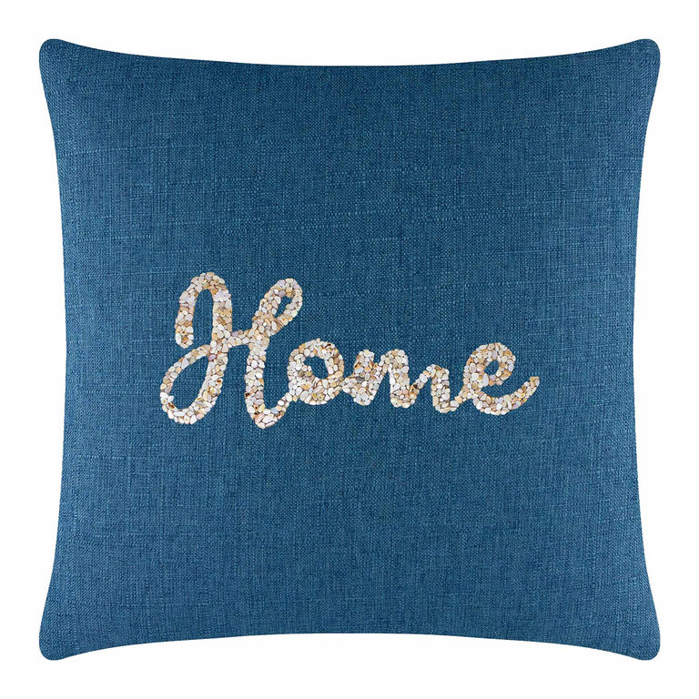 Square pillow with a textured royal blue fabric featuring a seashell "Home" design in beige and cream embellishments.