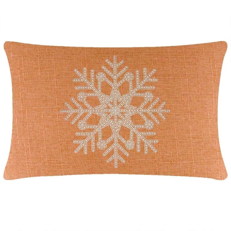Rectangular orange pillow with a textured fabric featuring a rhinestone snowflake design in the center.