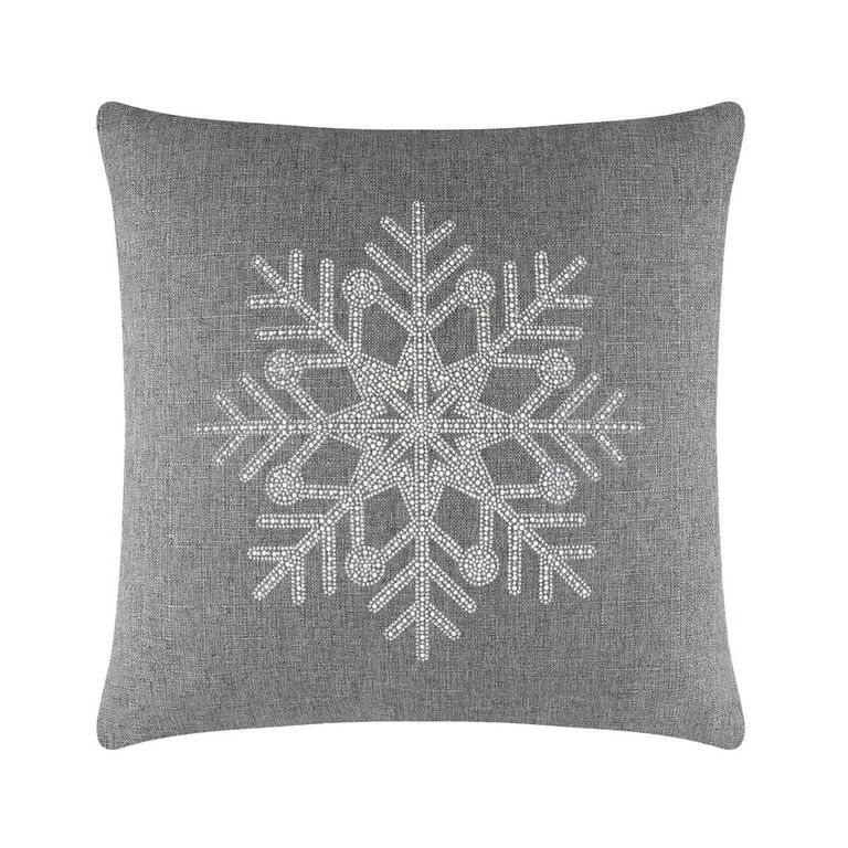 Gray&#x20;square&#x20;pillow&#x20;featuring&#x20;a&#x20;rhinestone&#x20;snowflake&#x20;design&#x20;on&#x20;a&#x20;textured&#x20;fabric&#x20;surface.