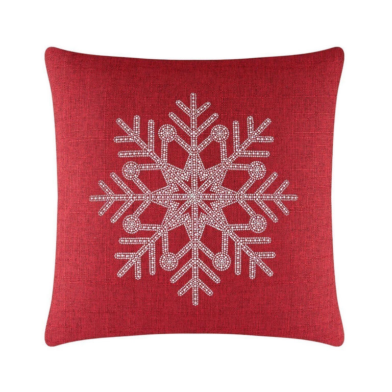 Red square pillow featuring a rhinestone snowflake design on a textured fabric surface.