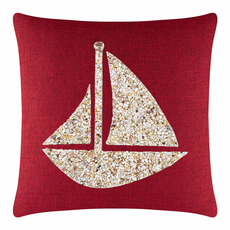 Red textured pillow featuring a seashell sailboat design in beige and cream tones.