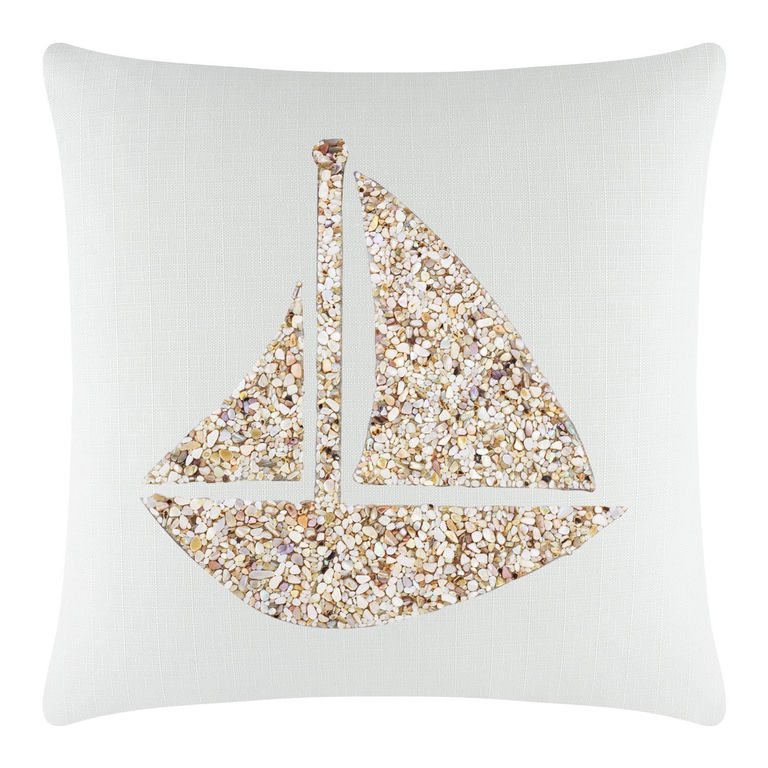 Square pillow with a textured light aqua background featuring a seashell sailboat design in beige and cream tones.