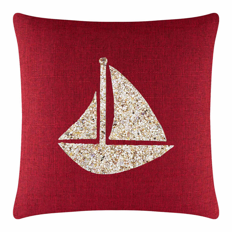 Red&#x20;textured&#x20;pillow&#x20;featuring&#x20;a&#x20;seashell&#x20;sailboat&#x20;design&#x20;in&#x20;beige&#x20;and&#x20;cream&#x20;tones.