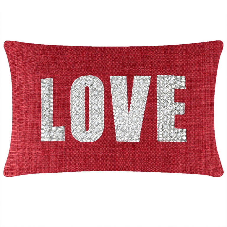 Red&#x20;rectangular&#x20;pillow&#x20;featuring&#x20;the&#x20;word&#x20;&quot;LOVE&quot;&#x20;in&#x20;rhinestones&#x20;and&#x20;faux&#x20;pearls&#x20;on&#x20;a&#x20;textured&#x20;woven&#x20;surface.