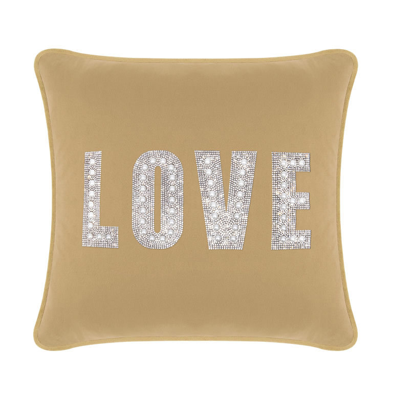 Champagne velvet pillow with rhinestone and faux pearl embellishments spelling "LOVE" in large letters.