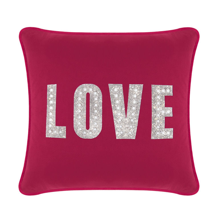 Fuchsia velvet pillow with rhinestone and faux pearl embellishments spelling "LOVE" in large letters.