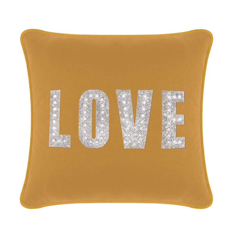 Gold velvet pillow featuring the word "LOVE" embellished with rhinestones and faux pearls.