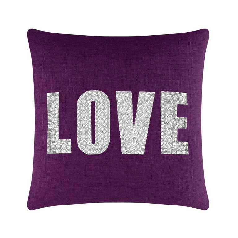 Purple square pillow featuring the word "LOVE" in rhinestones and faux pearls on a textured surface.