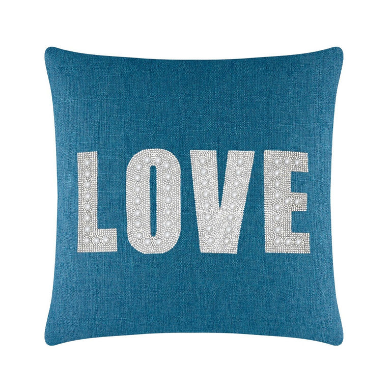 Teal woven pillow featuring the word "LOVE" in rhinestones and faux pearls on a textured surface.