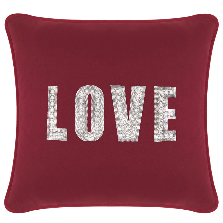 Burgundy velvet pillow with rhinestone and faux pearl embellishments spelling "LOVE" in a bold font.