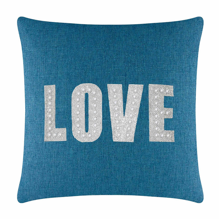 Square teal pillow featuring the word "LOVE" in rhinestones and faux pearls on a textured fabric surface.