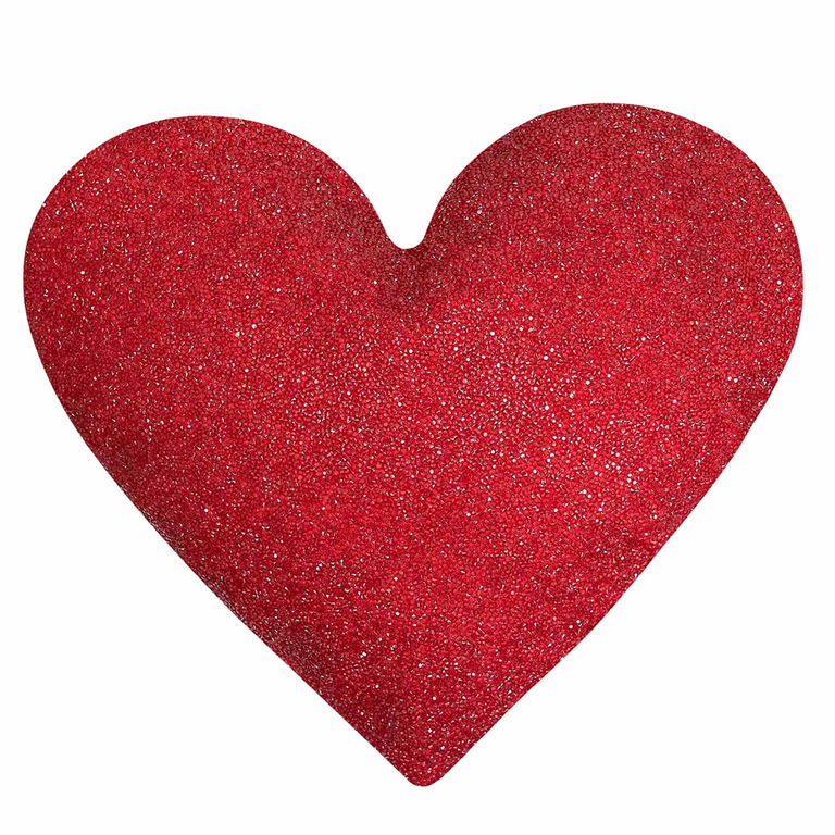 Red heart-shaped pillow covered in sparkling rhinestones with a smooth plush texture.