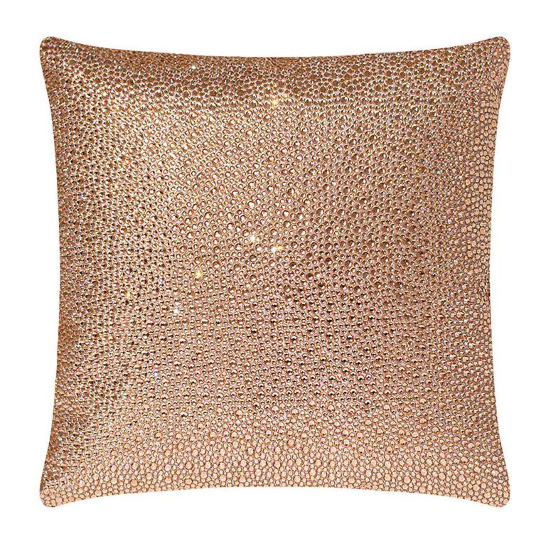 Square pillow covered in pink velvet with thousands of shimmering rhinestones reflecting light.