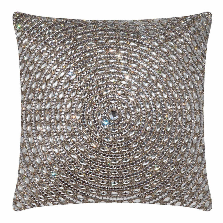 Square pillow covered in silver velvet with a spiral pattern of large glass rhinestones and a central rhinestone accent.