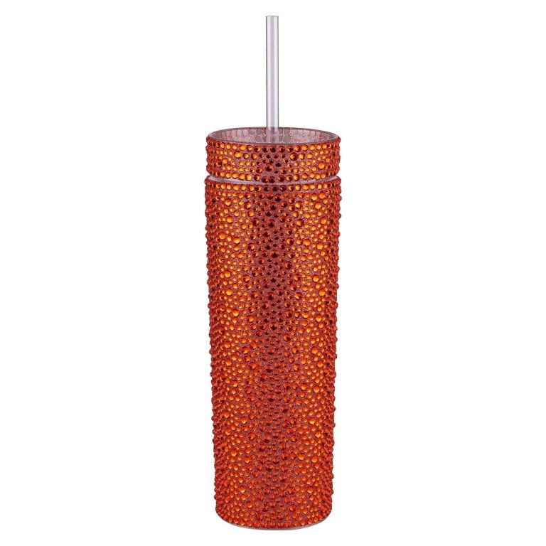 Orange rhinestone-encrusted tumbler with a clear straw cylindrical shape and textured surface.