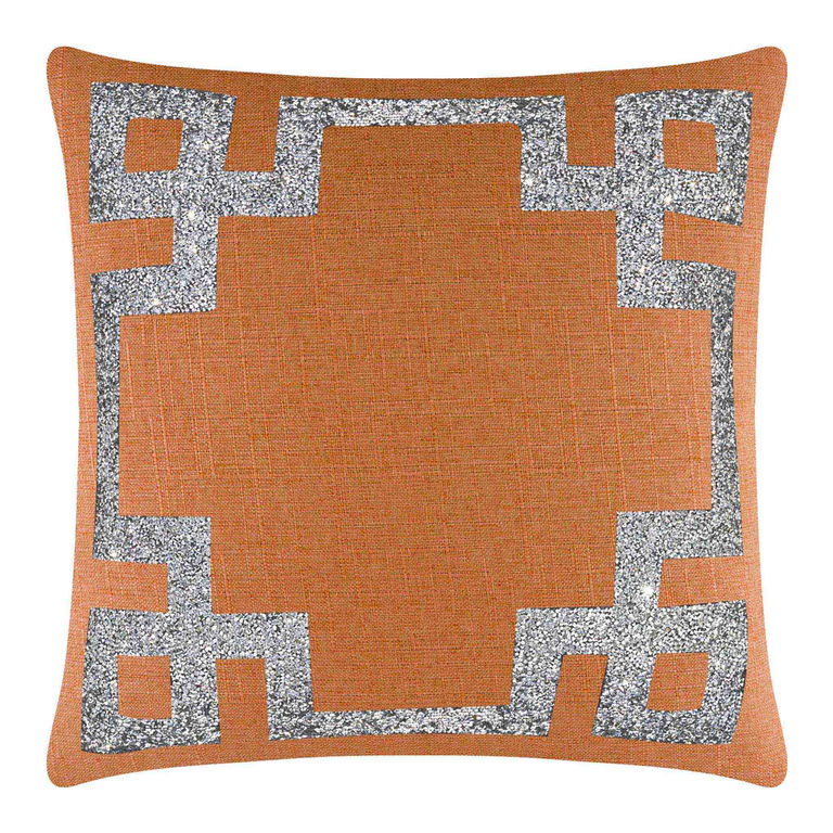 Orange pillow with a textured fabric featuring a silver rhinestone Greek Key border.