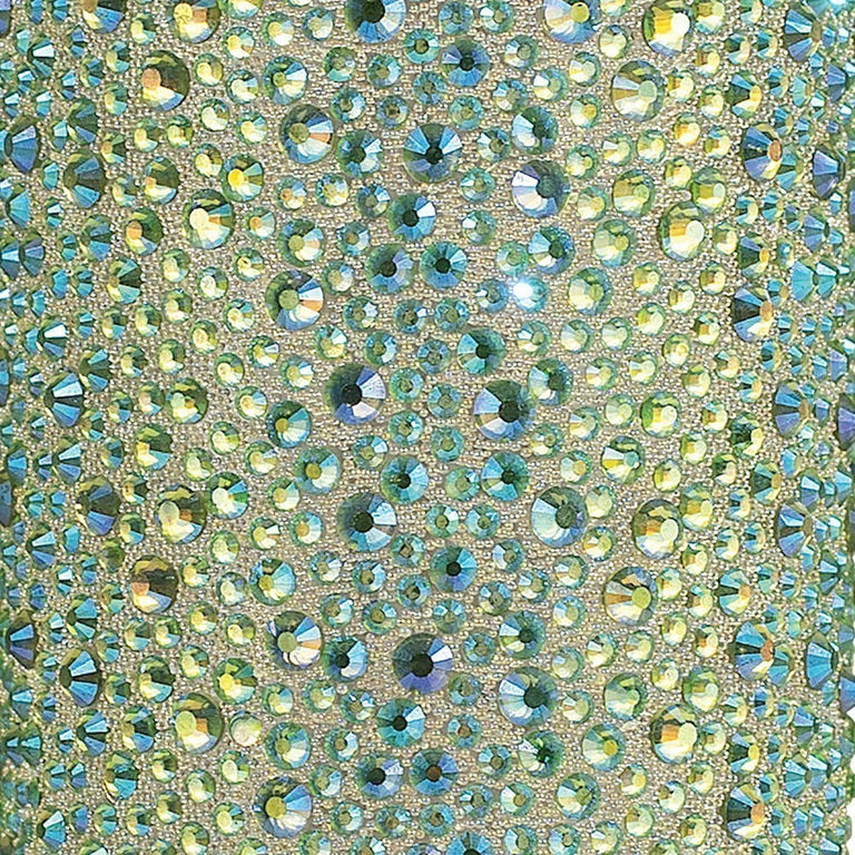 Lime iridescent rhinestones in various sizes arranged on a light textured background with sparkling reflections.