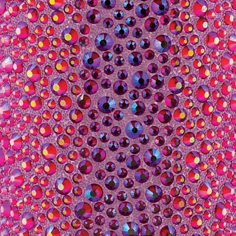 Red iridescent rhinestones of various sizes on a textured pink background with reflections and color shifts.